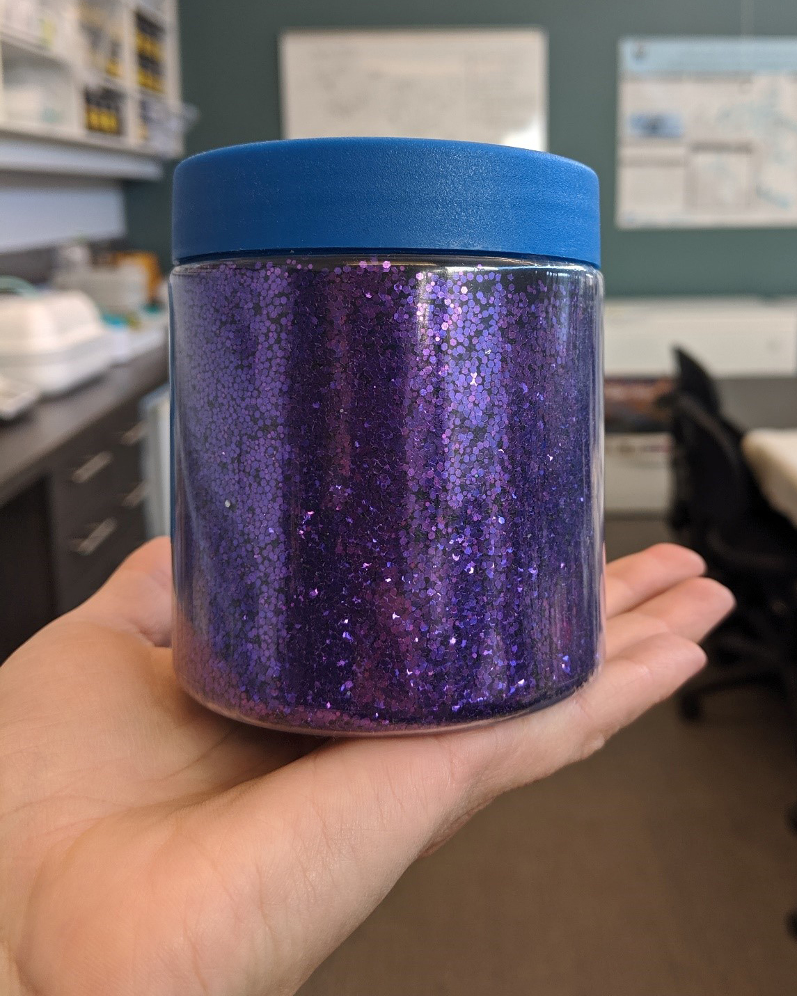 A large container of purple glitter